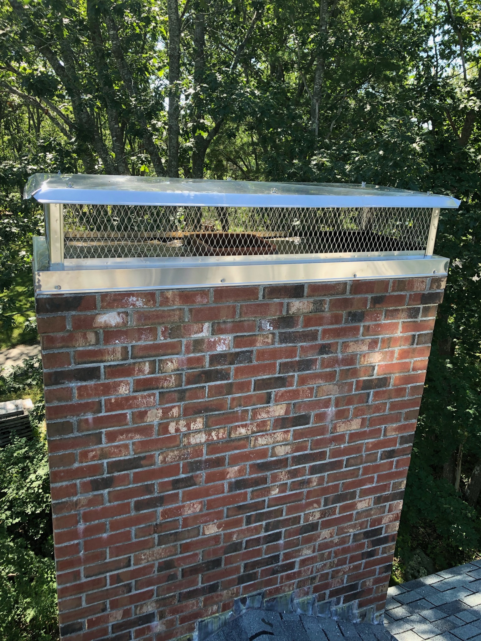 Custom Multi-Flue Chimney Cap Installation in Sanford Maine Custom multi-flue chimney cap installed on brick chimney in Sanford Maine by Frechette Chimney Sweeping