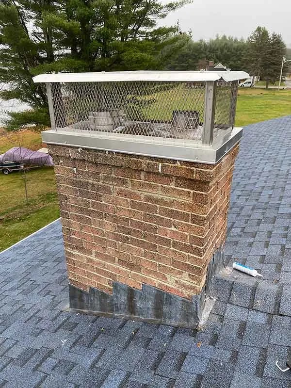 Copper chimney cap installation Portland, ME Stainless steel chimney cap replacement on brick chimney in Sanford Maine by Frechette Chimney Sweeping