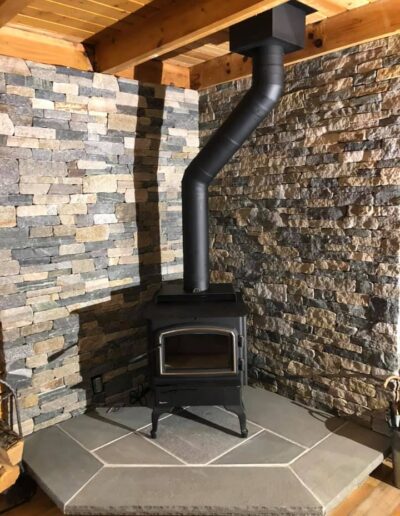 New wood stove installation with stone surround completed in Portland, ME.